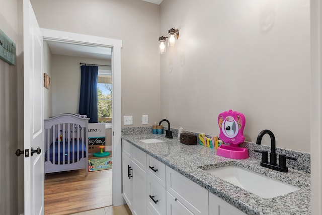 bathroom featuring vanity and hardwood / wood-style floors