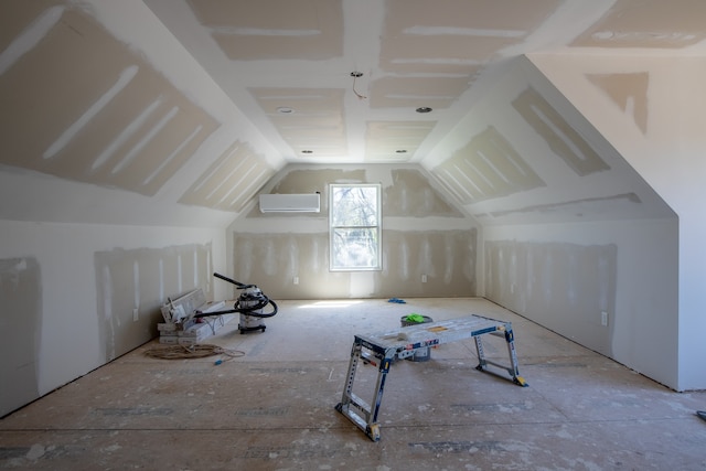 bonus room featuring lofted ceiling and a wall mounted AC