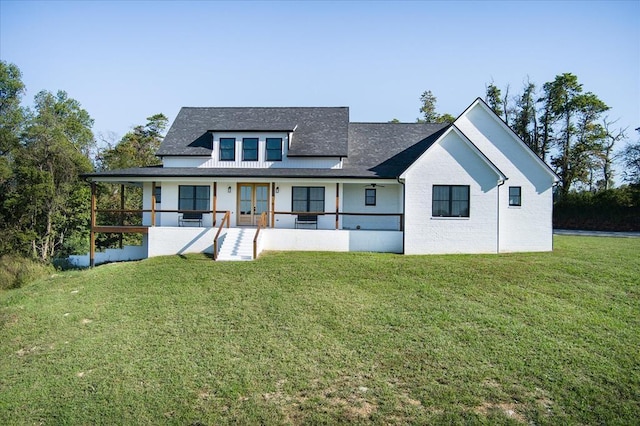 rear view of house with a lawn and french doors