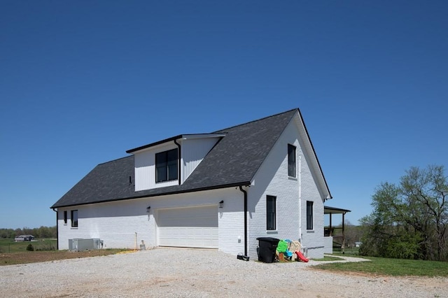 view of property exterior featuring a garage and central AC