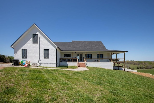 back of property with a patio and a yard