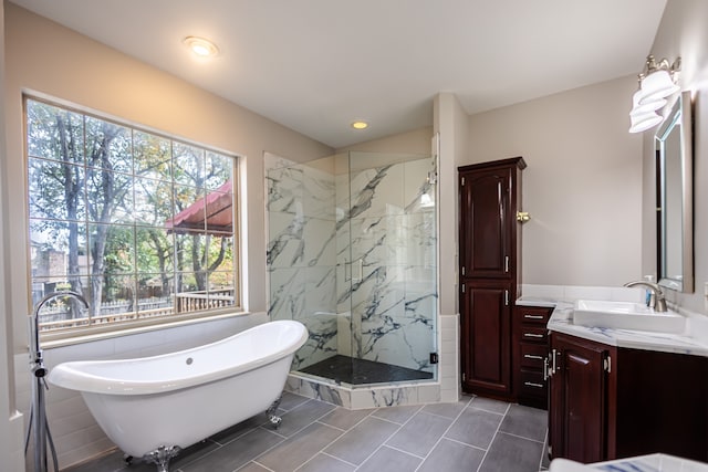 bathroom featuring tile walls, vanity, and plus walk in shower