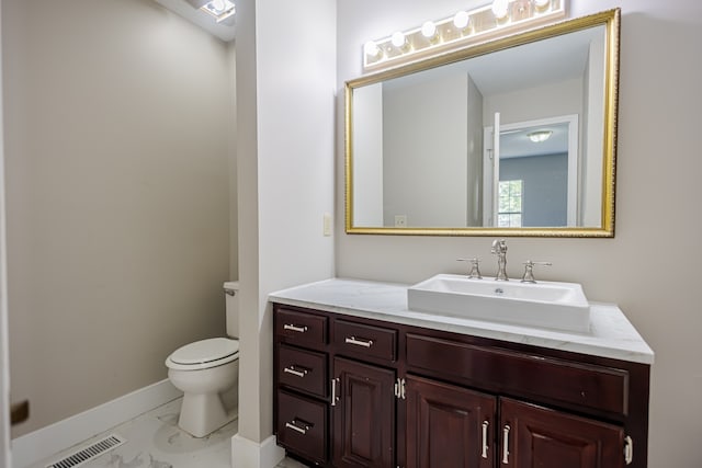 bathroom featuring toilet and vanity