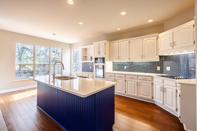 kitchen with white cabinetry, hardwood / wood-style flooring, appliances with stainless steel finishes, and sink