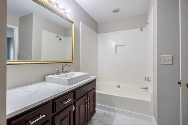 bathroom featuring vanity and tiled shower / bath