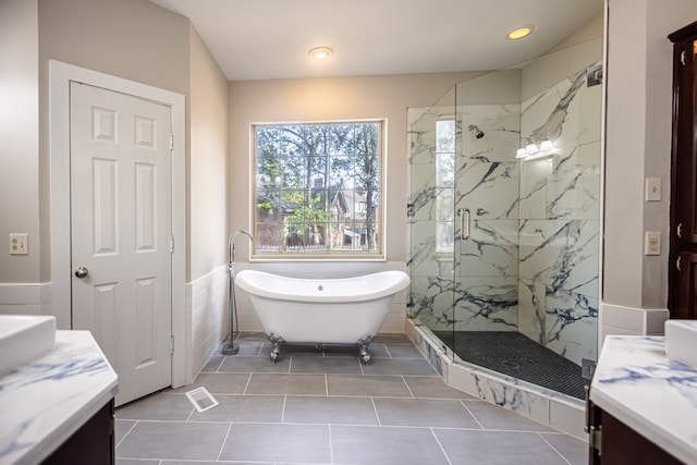 bathroom featuring tile walls, vanity, tile patterned flooring, and separate shower and tub