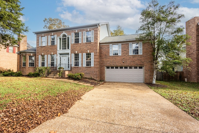 view of front of home featuring a garage and a front yard