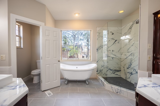 full bathroom with vanity, tile patterned floors, separate shower and tub, and toilet