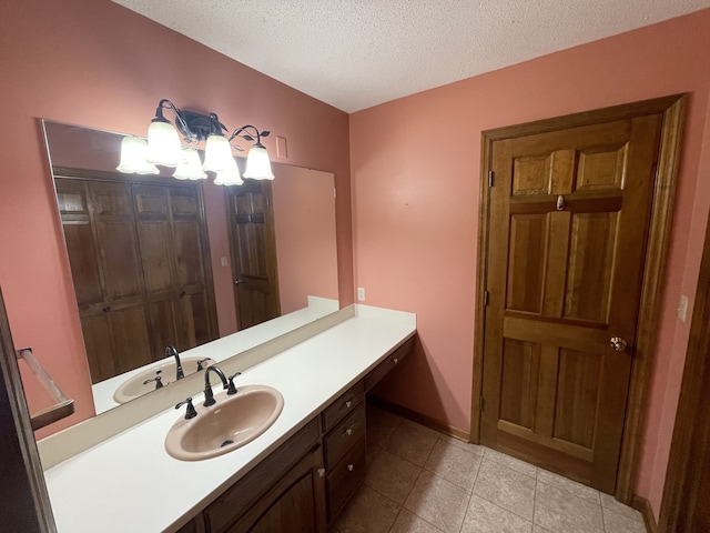 bathroom featuring vanity, tile patterned floors, and a textured ceiling