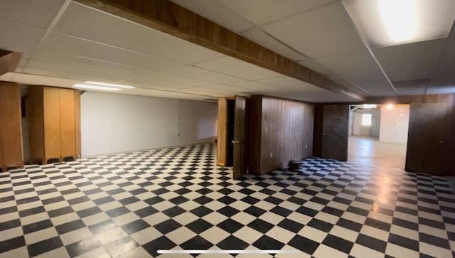 basement featuring wooden walls