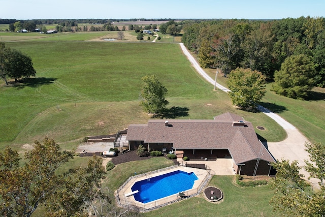 exterior space featuring a patio area, a yard, a diving board, and a rural view