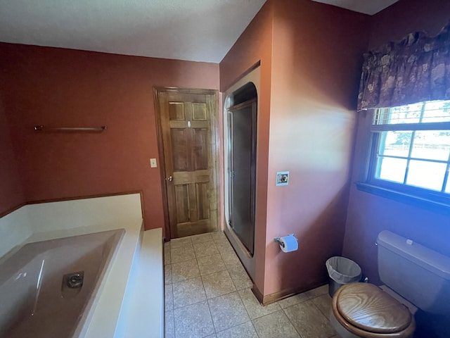 bathroom with toilet and a shower with shower door