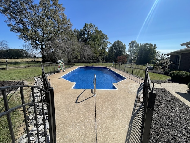 view of pool featuring a patio area and a lawn