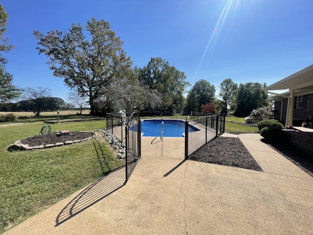 view of pool featuring a patio and a lawn