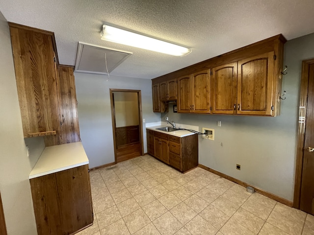 kitchen featuring sink and a textured ceiling