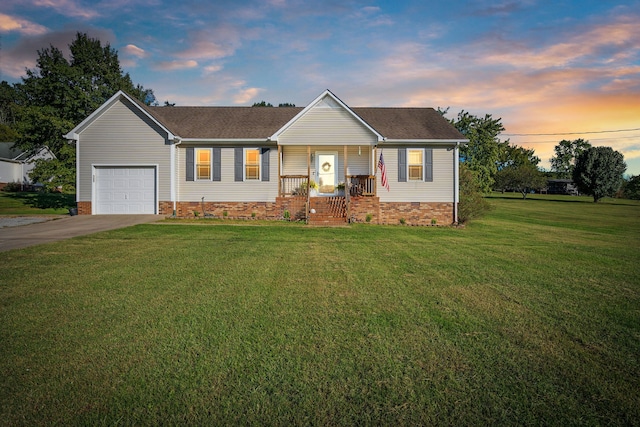 ranch-style home featuring a yard and a garage