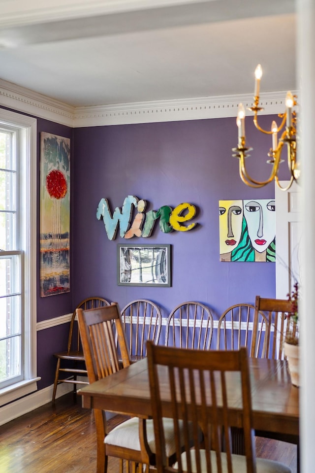 dining area featuring baseboards, wood finished floors, and a chandelier