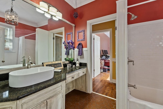 bathroom with tile patterned flooring, crown molding, vanity, a chandelier, and shower / tub combo