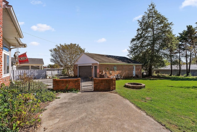 view of front facade with brick siding, a gate, a front yard, and fence private yard