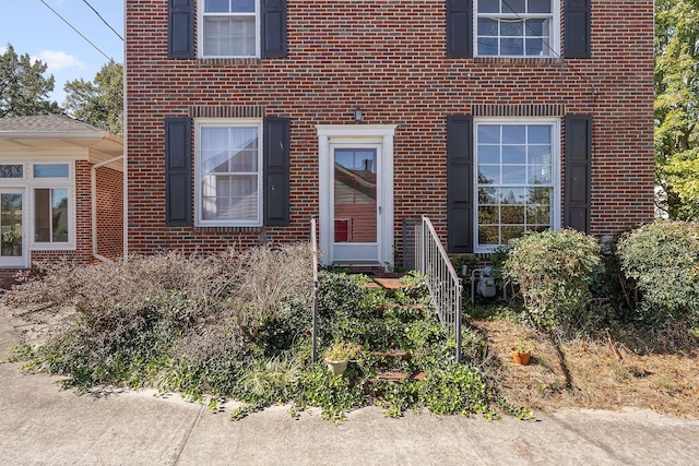 property entrance with brick siding