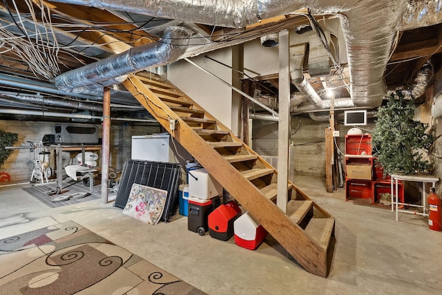 unfinished below grade area featuring stairs