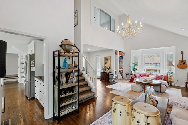 living room featuring an inviting chandelier, high vaulted ceiling, and dark hardwood / wood-style flooring