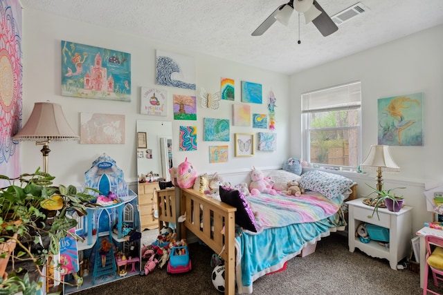 carpeted bedroom featuring a textured ceiling and ceiling fan