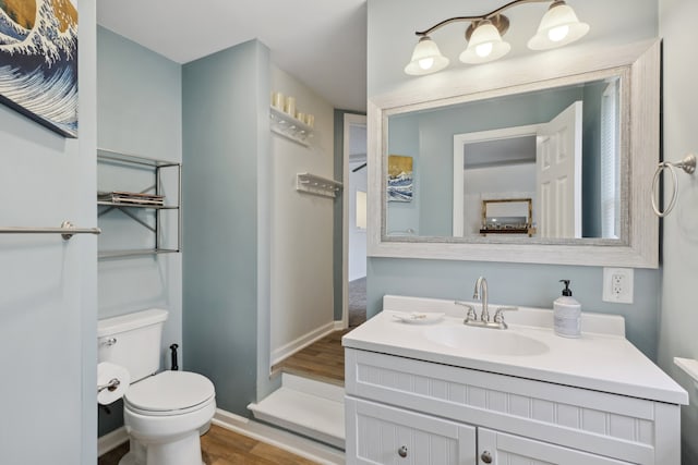 bathroom featuring vanity, toilet, and wood-type flooring