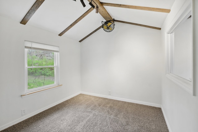 carpeted empty room featuring lofted ceiling with beams