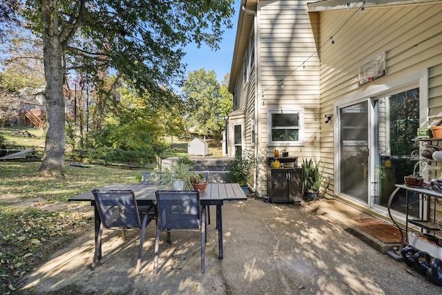 view of patio / terrace with a shed