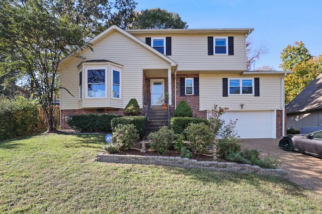 view of front of property with a front yard and a garage