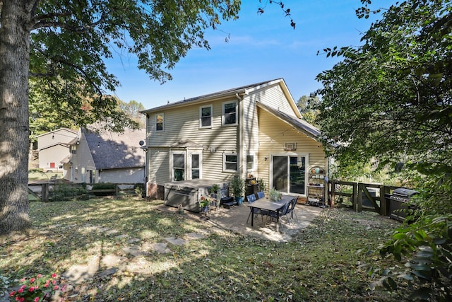 rear view of property featuring a yard and a patio