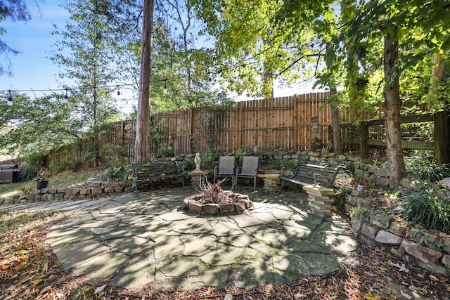 view of patio / terrace featuring an outdoor fire pit