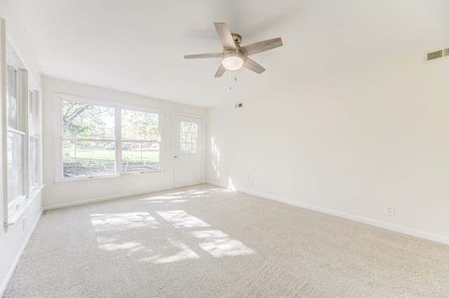 carpeted empty room featuring ceiling fan