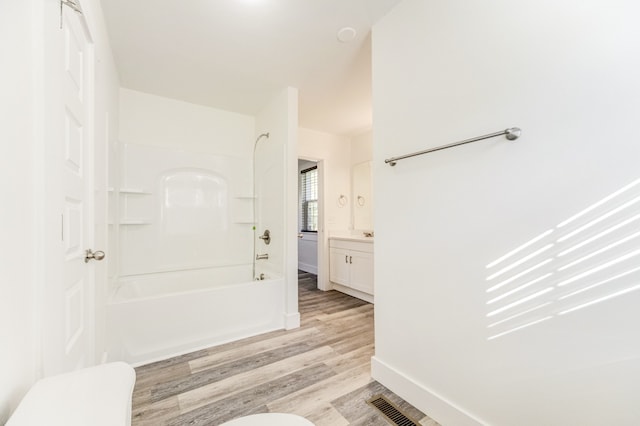 full bathroom featuring vanity, hardwood / wood-style floors, toilet, and shower / bath combination