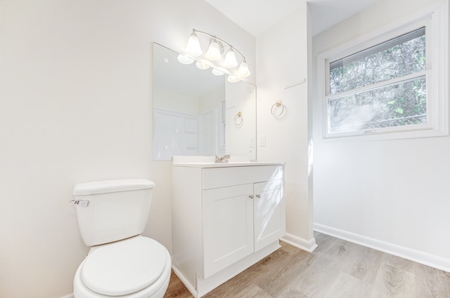 bathroom with vanity, hardwood / wood-style floors, and toilet