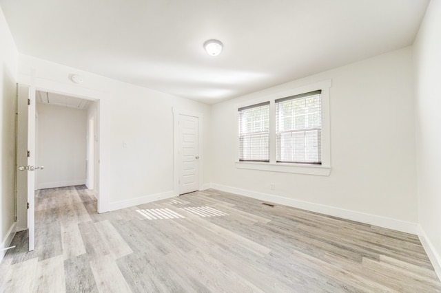 spare room with light wood-type flooring