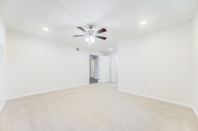 carpeted spare room featuring ceiling fan