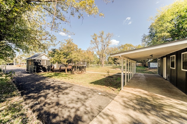 view of yard featuring a carport and a deck