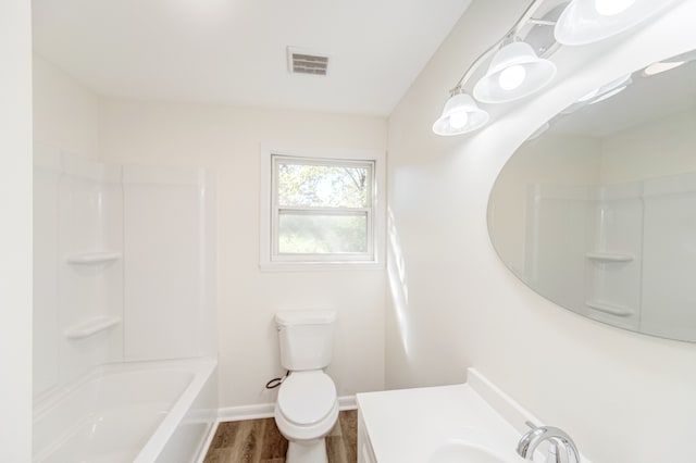 full bathroom featuring vanity, toilet, hardwood / wood-style flooring, and shower / washtub combination