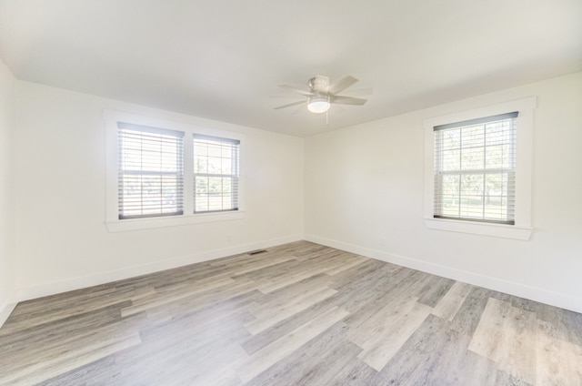 unfurnished room with ceiling fan and light hardwood / wood-style flooring