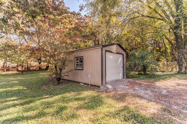 view of outbuilding with a yard and a garage