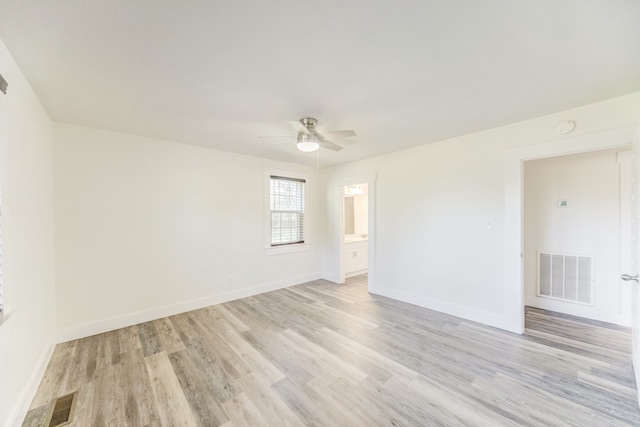 spare room with light wood-type flooring and ceiling fan