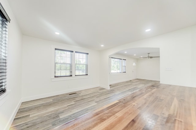 empty room with light hardwood / wood-style flooring and ceiling fan