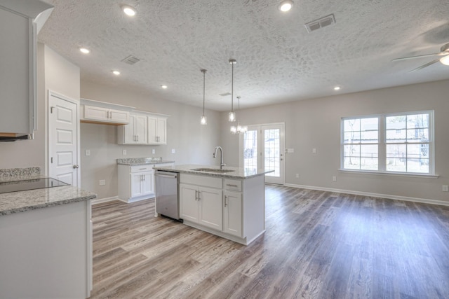 kitchen featuring white cabinetry, stainless steel dishwasher, and light stone counters