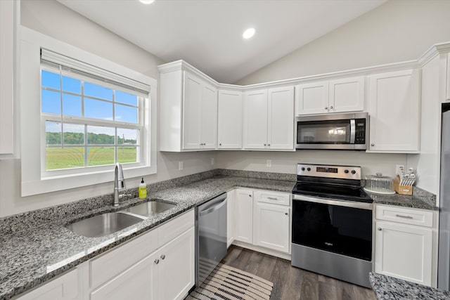 kitchen featuring lofted ceiling, dark wood-type flooring, sink, white cabinets, and appliances with stainless steel finishes