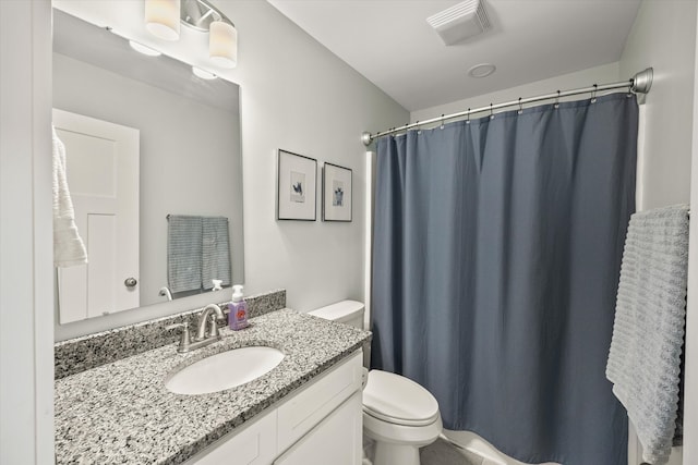 bathroom featuring vanity, toilet, and walk in shower