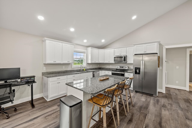 kitchen featuring lofted ceiling, sink, white cabinets, and stainless steel appliances