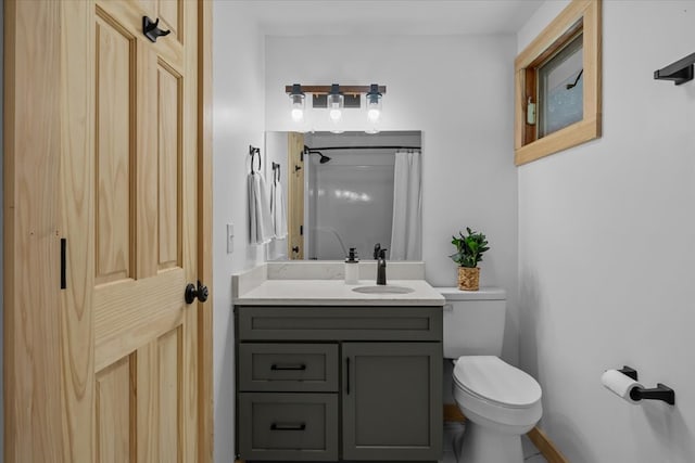 bathroom featuring vanity, toilet, and walk in shower