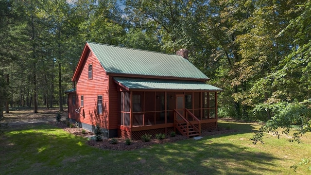 exterior space featuring a sunroom and a front yard